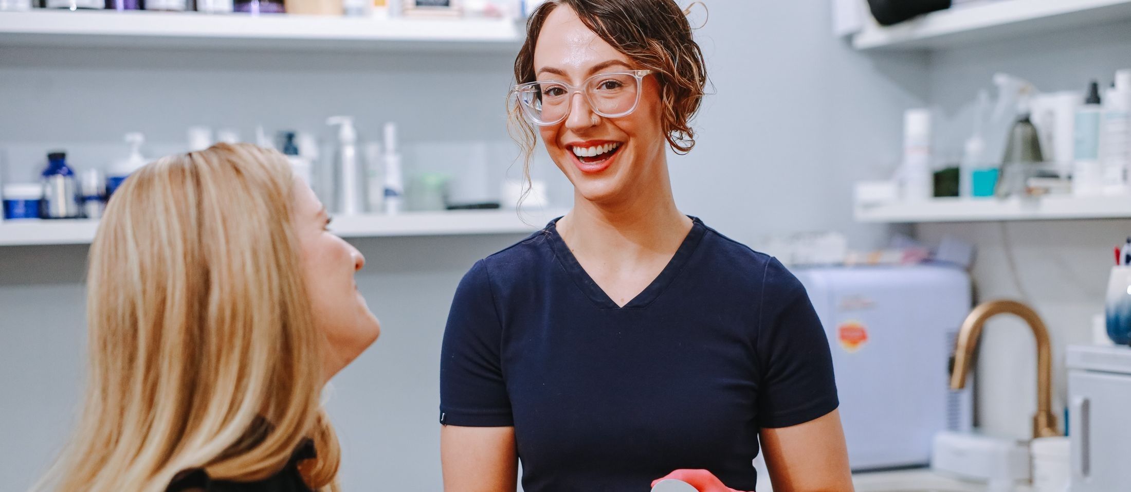 a woman in scrubs smiling