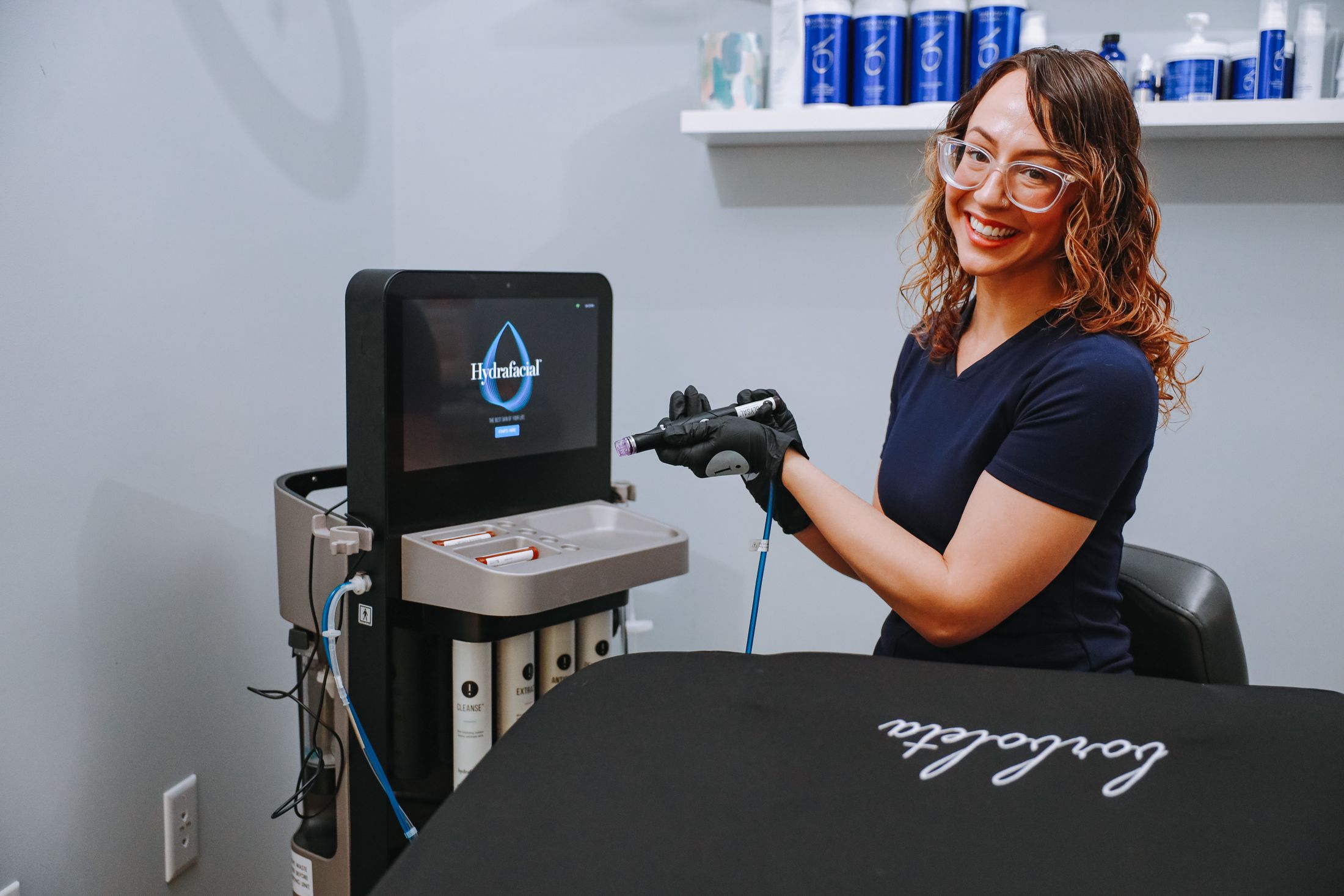 Technician preparing for a HydraFacial treatment.