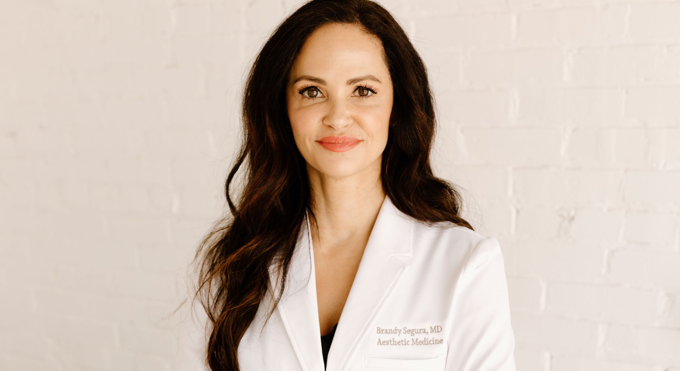 Doctor in white coat against white background