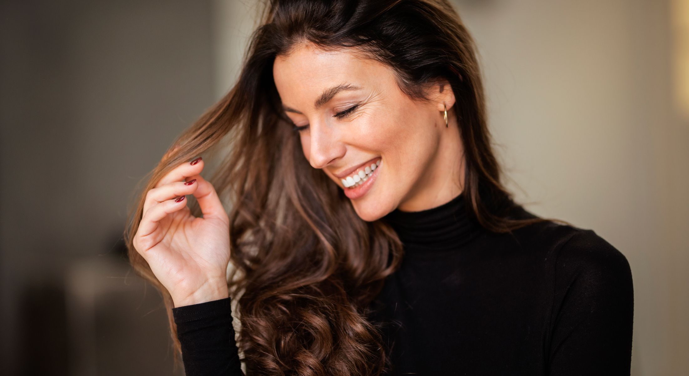 Smiling woman with long, flowing hair.