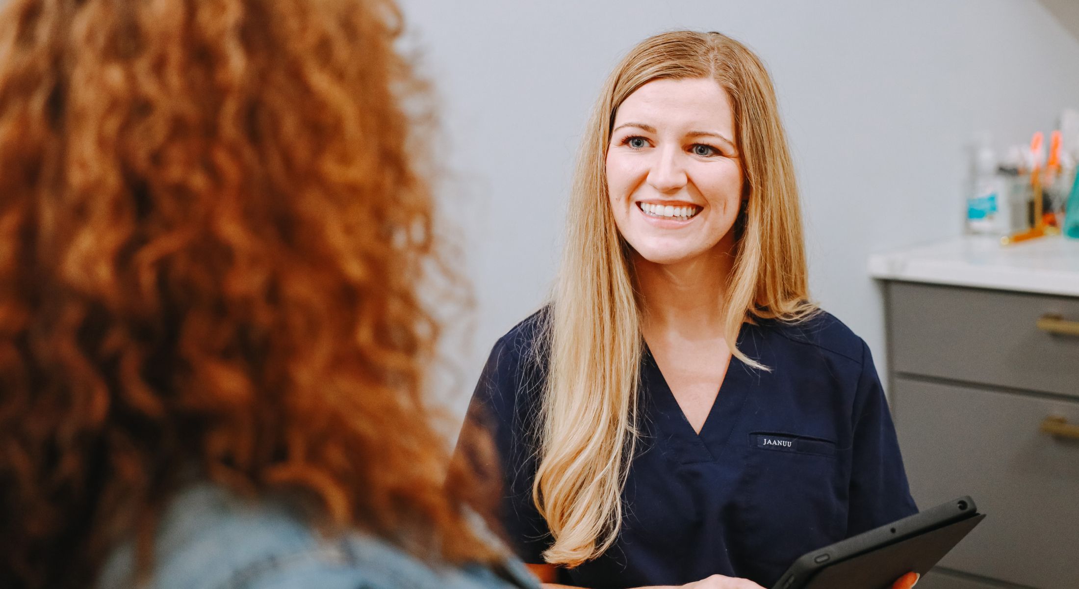 Healthcare professional smiling at a patient.