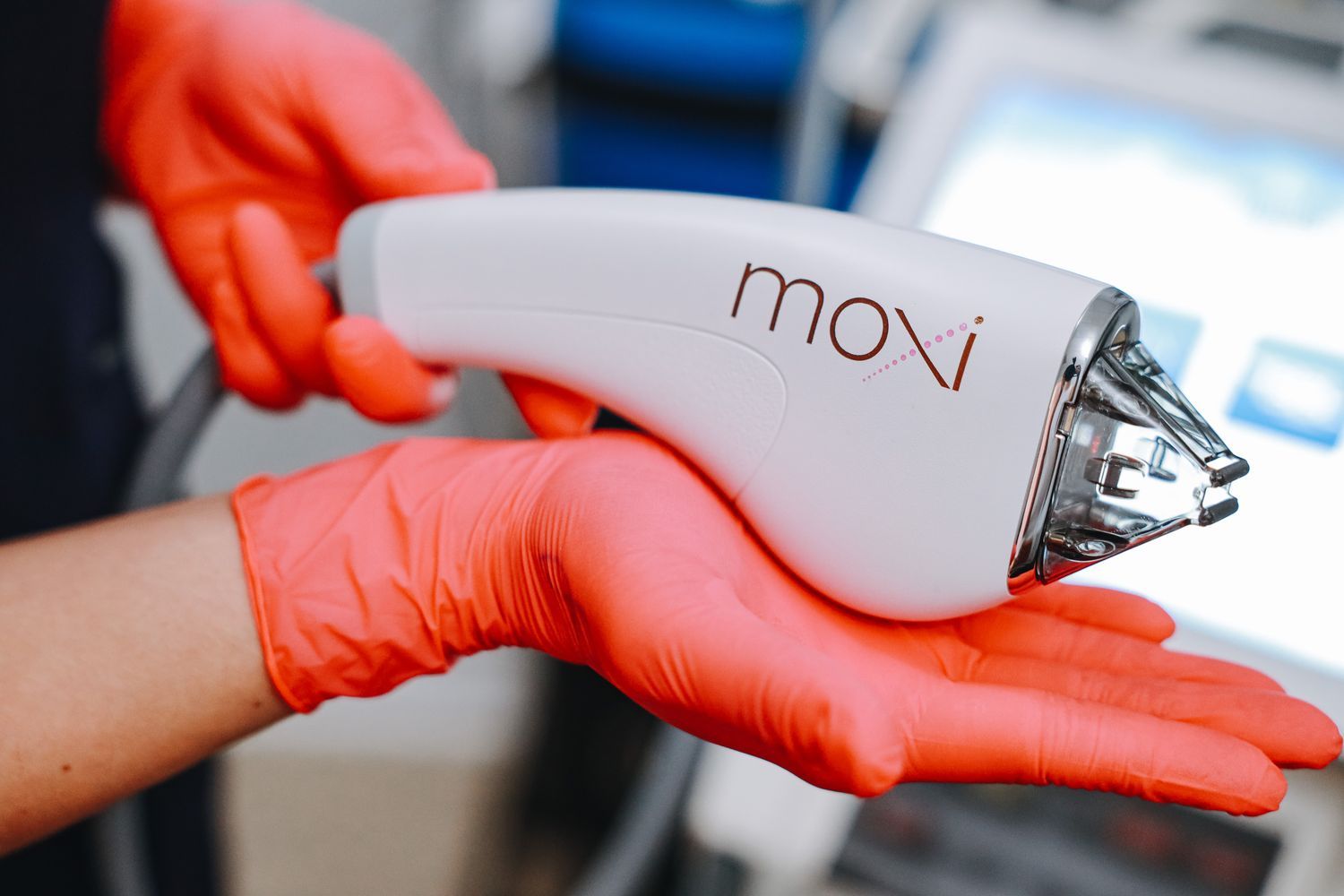 Moxi laser device held with gloved hand.