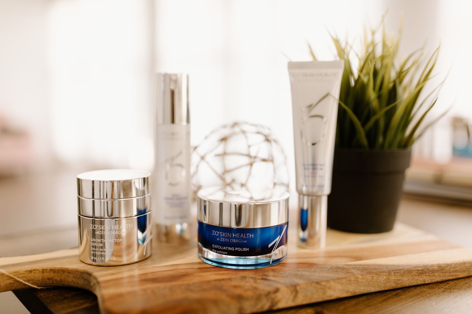 Skincare products displayed on a wooden tray.